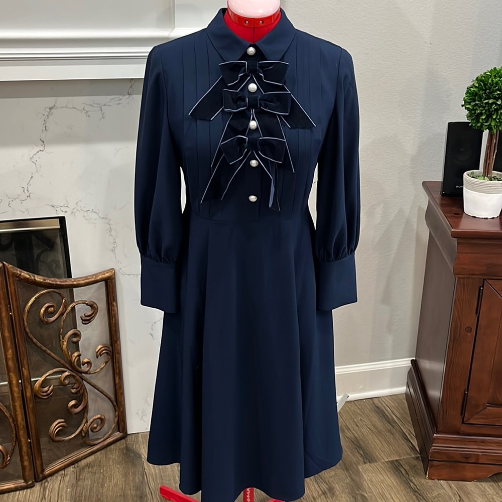 Navy dress with velvet bows and pearl button accents